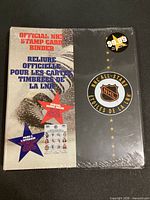 Front of sealed NHL stamp card binder showing title, logo, price sticker