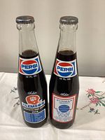 Front view of both sealed Pepsi commemorative bottles showing Clemson and Furman graphics