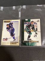 Fronts of both oversized promo cards in sleeves