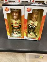 Front view of both boxed bobbleheads showing player names and packaging condition