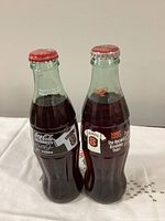 Two sealed 8oz Cal Ripken 1995 record bottles front view on tablecloth