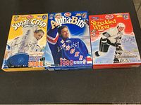 Front view of three Wayne Gretzky Post cereal boxes: Sugar Crisp 1988, Alpha-Bits 1999, Shredded Wheat 1993