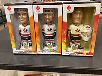 Front view of three boxed bobble heads showing players Lemieux, Yzerman and Brodeur