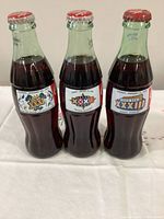 Front view showing three unopened Coca-Cola bottles with Super Bowl XXXI, XXXII, XXXIII labels