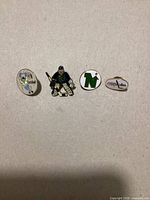 Front view showing all four enamel hockey pins in a row