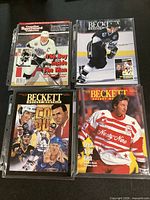 Four hockey magazines in protective sleeves, covers visible