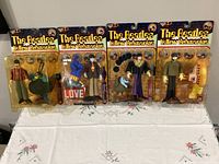 Front view of four sealed Beatles Yellow Submarine action figures