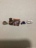 Five NHL logo pins laid out side by side on neutral background