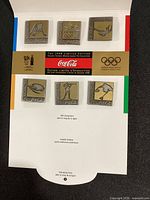 Six square Coca-Cola Nagano 1998 Olympic pins mounted in original folder