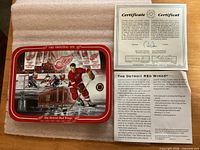Front of plate with Gordie Howe image, COA and info sheet visible