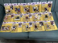 All 15 sealed Kenner Starting Lineup 1996 NHL figures displayed on sofa
