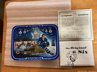 Front view of plate with certificate and leaflet