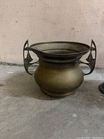 Full view of brass pot showing shape and both decorative handles