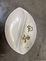 Top view of divided dish showing shape, floral design, gold trim