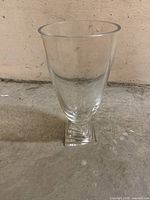 Full view of clear glass vase standing upright