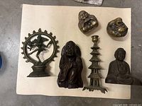 Group shot of all six figurines laid on paper