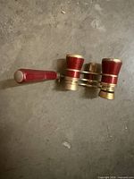 opera glasses side view showing red enamel barrels and brass rings