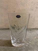 Front view of clear cut crystal Royal Doulton vase showing leaf pattern and label