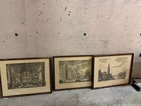 All three framed prints leaning against wall