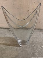 Frontal view showing V-shaped rim and clear glass body