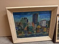 Front view of framed acrylic skyline painting