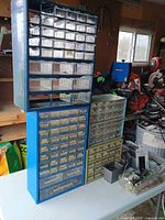 Front view of three drawer cabinets and contents