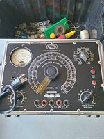 Front panel of Sprague Model CC capacitor analyzer showing meter, large dial, knobs, power cord