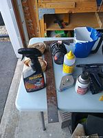 Overview of spray bottle, veneer roll, knee pad, edge banding, lubricant can, staple gun