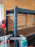 Side view of steel shelving showing top and middle shelves