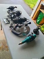 Tabletop view of all seven corded power tools and accessory