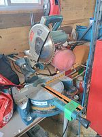 Overall view of Ryobi sliding compound miter saw showing blade guard, base and handle