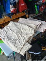 Folded beige canvas drop cloths on table