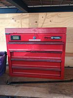 Front view of red ProSteel top tool chest showing four drawers, lock, and digital display