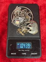 All scrap pieces on digital scale showing 1.0439 oz