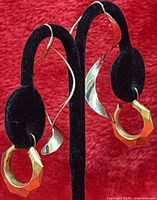 Front view showing both earring pairs on stand