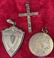 Front view of all three pendants on red fabric