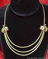 front view of gold-filled triple-strand necklace on bust