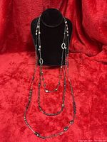 Necklace displayed on bust showing full 40-inch triple-strand design and bead arrangement