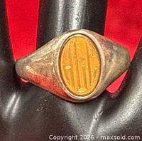 Front view of sterling and gold signet ring showing monogrammed oval face