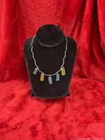 Necklace front on stand showing full design and sea glass colours