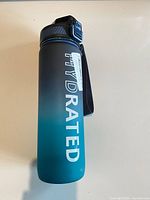 Full bottle side view showing HYDRATED text and strap
