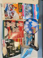 All seven craft kits laid out showing fronts of packages and loose supplies