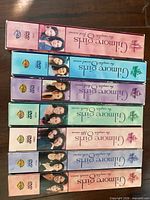 Spines of the seven Gilmore Girls DVD boxes stacked
