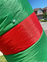 Close-up of green and red nylon material showing valve and fabric condition