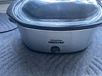 Front view showing Rival Crock-Pot branding, control dial, glass lid