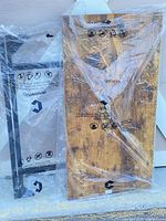 Wood tabletop and metal frame wrapped in plastic