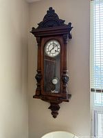 Full view of Vienna regulator wall clock hanging on wall