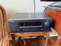 Front angled view of Denon AVR-1912 receiver on table