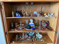 Cabinet with three shelves of assorted decorative items