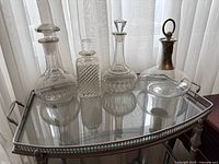 All four crystal decanters displayed on mirrored tray